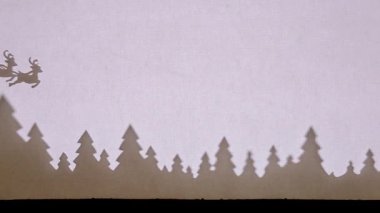 Kukla Gölge Tiyatrosu. Noel Baba ve ren geyiği ormanda uçuyor. Üzerine yapış.
