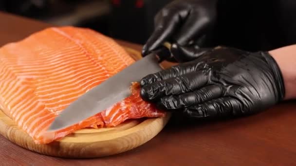 Chef Black Gloves Cuts Salmon Table — Stock Video