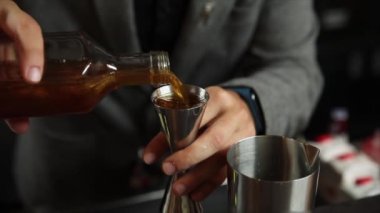 Barmen buzlu alkollü bir kokteyl hazırlar.