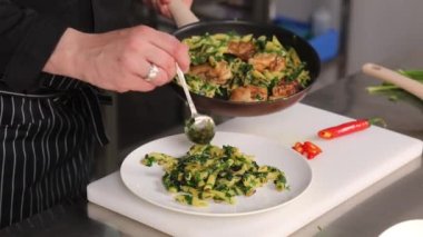 Şef mutfakta tavuk pişiriyor.