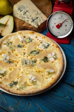 Armut ve Gorgonzola ile ahşap bir masada pizza.