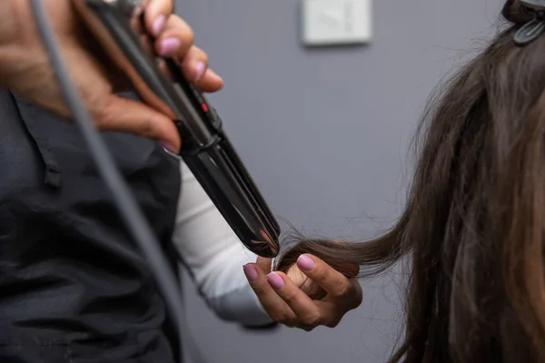 hairdresser drying hair dryer in salon