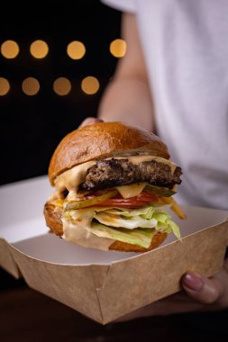 mouth-watering burger with cutlet, cheese and vegetables