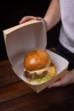 mouth-watering burger with cutlet, cheese and vegetables