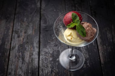 ice cream with chocolate and mint on wooden background