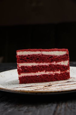delicious chocolate cake with red and black background