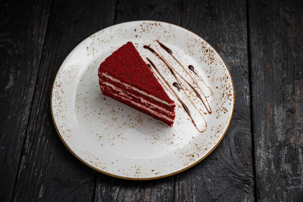 chocolate cake with cream and nuts on a wooden background