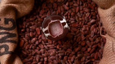 brewed cocoa drink on the background of cocoa beans