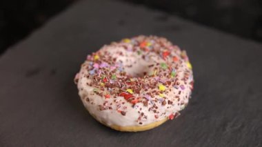 Beautiful doughnuts covered in chocolate glaze, sprinkles, marshmallows and chopped nuts