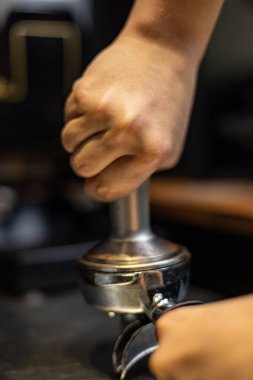 close-up of barista pouring coffee machine in cafe