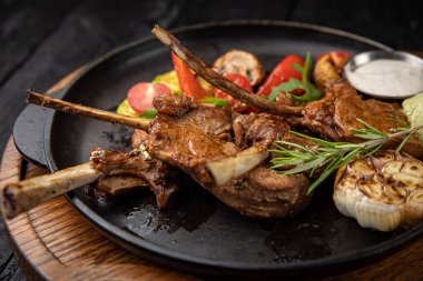 Siyah arka planda ızgara et ve sebze.