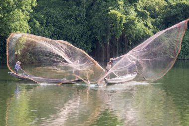 Landscape photo: fishermen casting fishing nets on Nhu Y river. Time: June 20, 2022. Location: Hue City.  