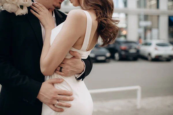 Damat gelini belinden kucaklıyor.