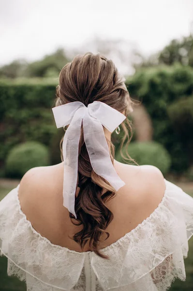 bridal hairstyle with white bow