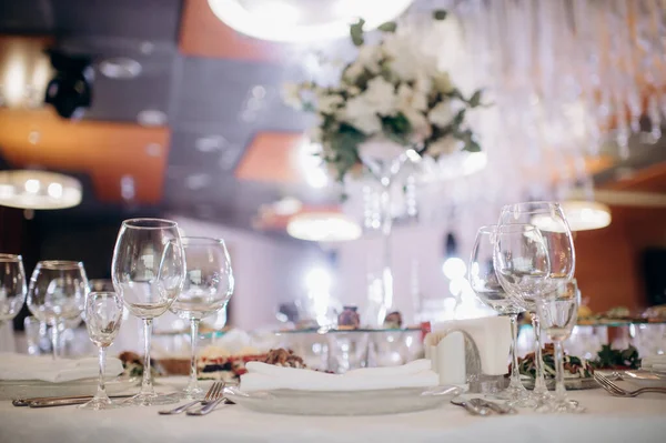 Düğün masasında parlayan bardaklar yan görünüm ayarlıyor.