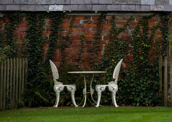 Damp Garden Scene Showing Old Iron White Table Chairs Wet — Stock fotografie