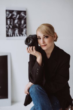 Kyiv, Ukraine, 18 february 2022. Beautiful woman photographer, journalist, posing in her studio. Soft selective focus.