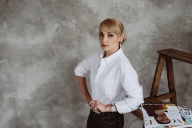 Kyiv, Ukraine, 18 february 2022. Successful confident young business woman, CEO, bank manager, bank worker in formal wear, isolated on gray background. Soft selective focus