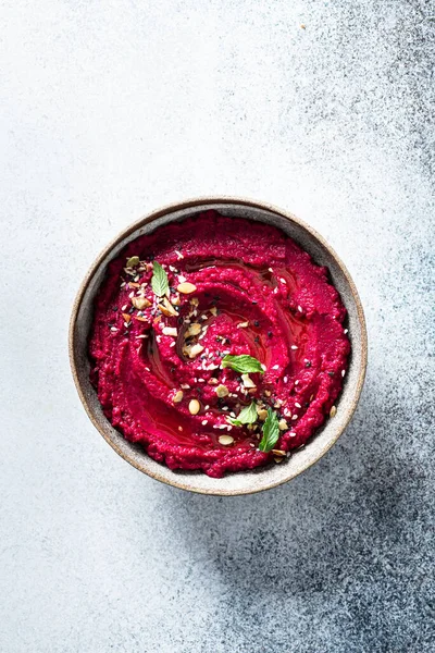 Beet hummus in a ceramic bowl Royalty Free Stock Images