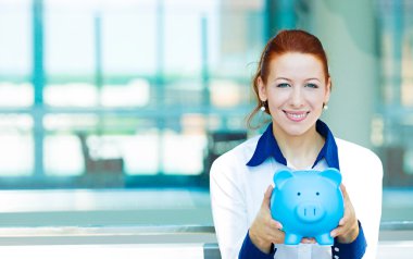 Business woman holding piggy bank