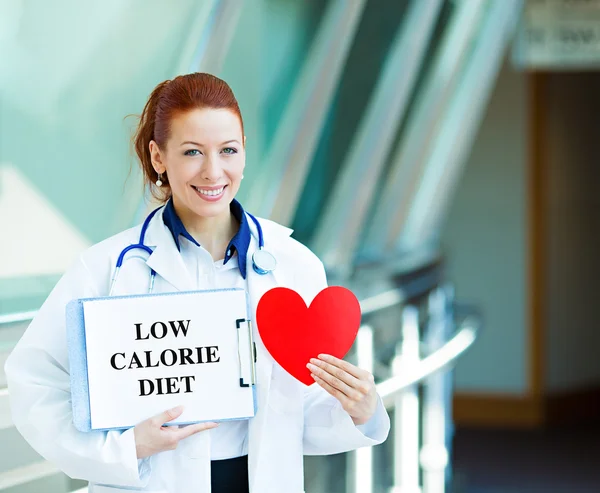 Doctor sosteniendo signo bajo en calorías —  Fotos de Stock