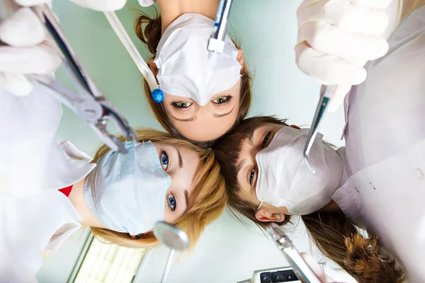 Doctors in mask over patient head — Stock Photo, Image