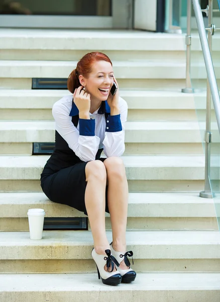 Woman talking on phone outside her corporate office — Stock Photo, Image