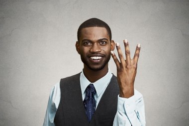 Smiling man giving four times gesture with hand clipart