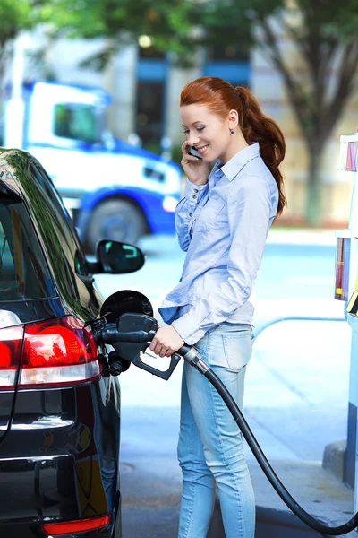 Attractive woman refueling her car at gas station — Stock Photo, Image