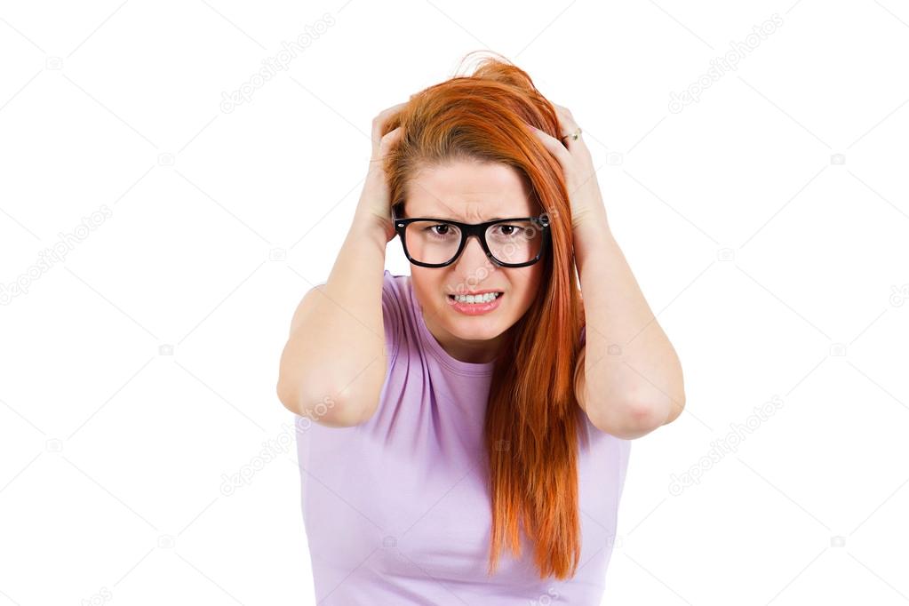 Stressed young woman pullling her hair out