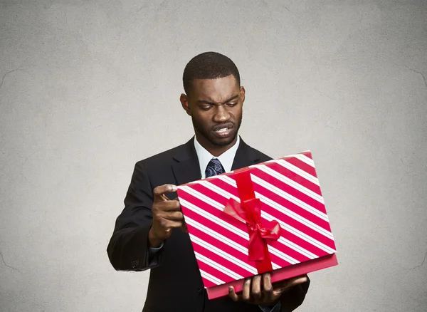 Unhappy man, displeased with new gift — Stock Photo, Image