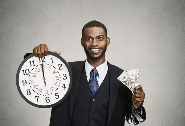 Businessman holding wall clock and cash in hands. Time is money — Stock Photo, Image