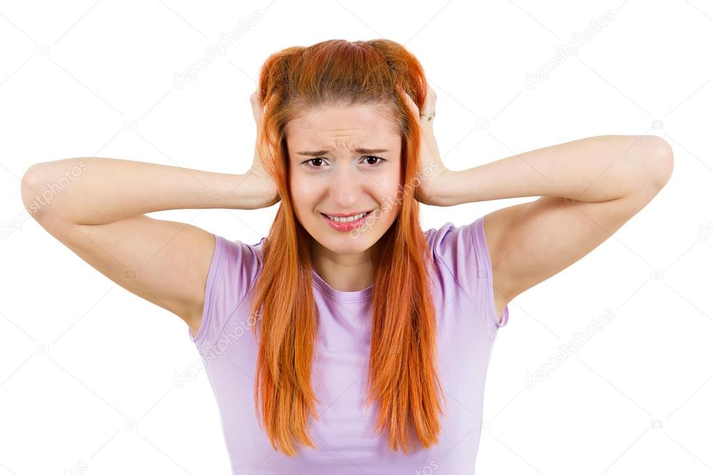 Stressed woman covering her ears, going nuts