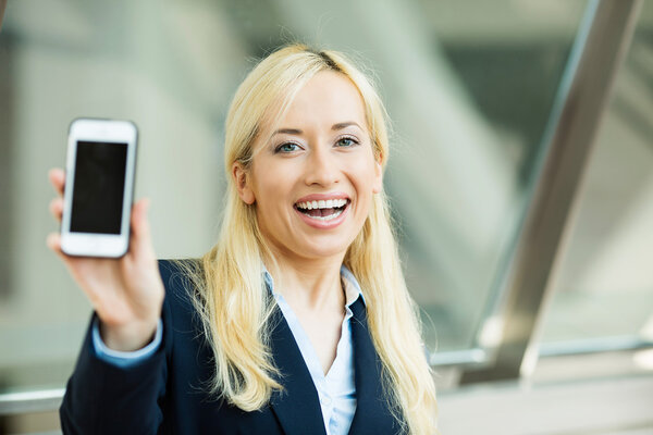 Happy excited businesswoman showing her smart phone