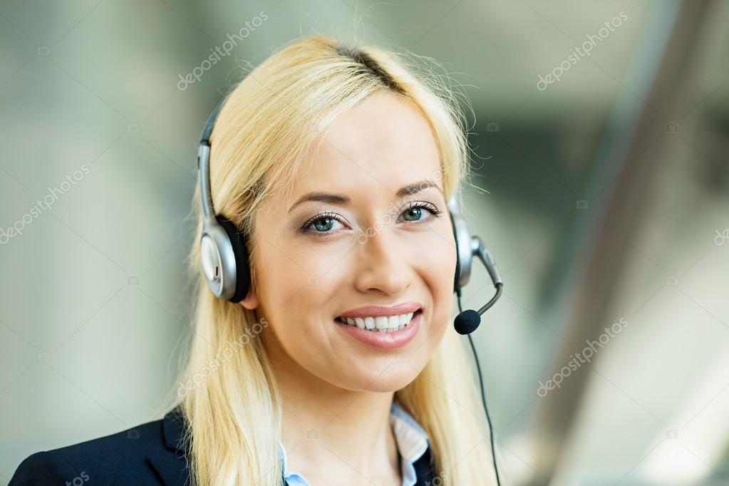 Female customer service representative on hands free device Stock Photo