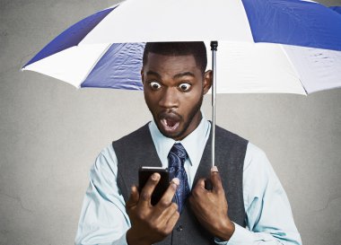 Shocked executive reading breaking news on a rainy day clipart