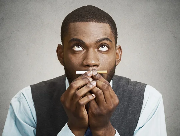 Headshot of a young business man holding, smelling, craving a ci — Stock Photo, Image