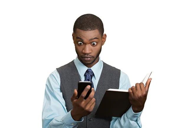 Shoked man with phone holding book — Stock Photo, Image