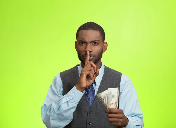 Bribery man with dollar bills in hand and quiet gesture — Stock Photo, Image