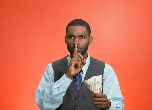 Bribery man with dollar bills in hand and quiet gesture — Stock Photo, Image