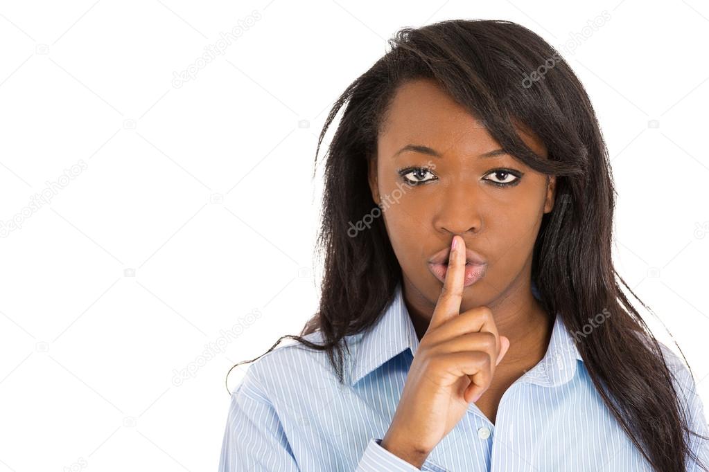 Woman placing finger to lips. Asking to keep secret