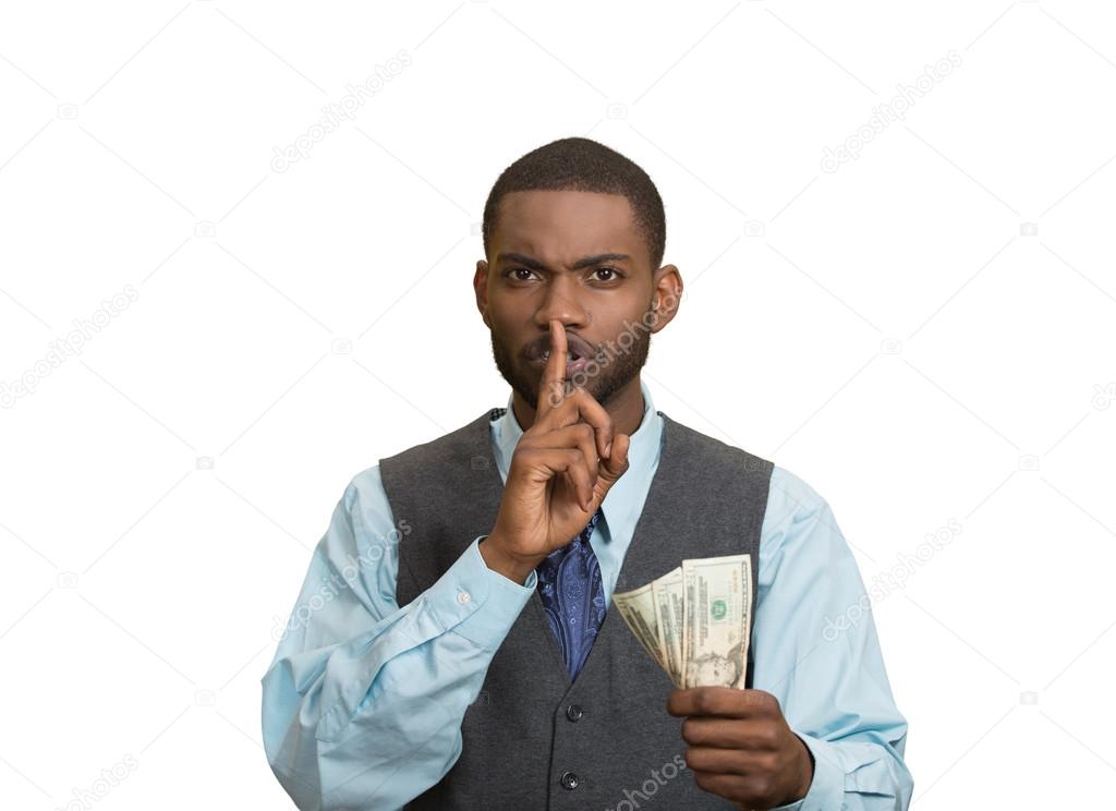 Bribery man with dollar bills in hand and quiet gesture