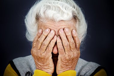 Closeup portrait depressed old woman covering her face with hand clipart