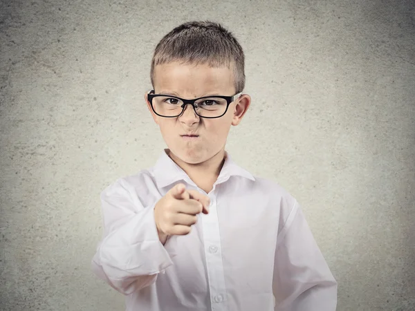 Angry bossy boy pointing finger at someone — Stock Photo, Image