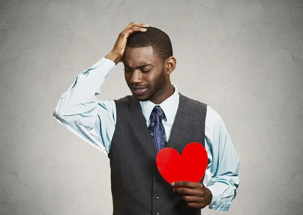 Sad company man holding red heart, crying — Stock Photo, Image