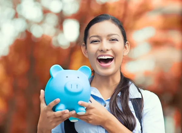 Happy woman holding piggy bank — Stock Photo, Image