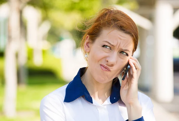 Unhappy woman talking on a phone — Stock Photo, Image