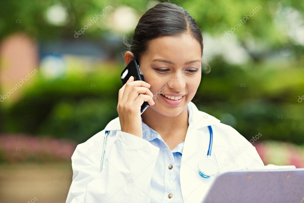 Happy doctor talking on a phone