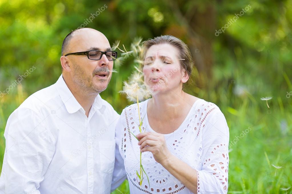 Happy mature couple enjoying weekend day in a park
