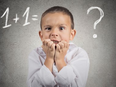 Confused, anxious boy trying to solve math problem clipart